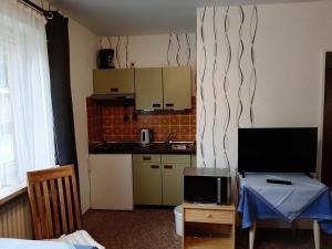 a small kitchen with a table and a kitchen with a tableablish at Goode Wind in Norden