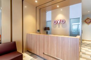 a company lobby with a sign on the wall at Super OYO 3159 Festive Inn in Medan