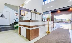 a lobby with a reception desk in a building at Treebo Trend Atithi Comforts 1 Km From Nisargadhama Forest in Kushālnagar