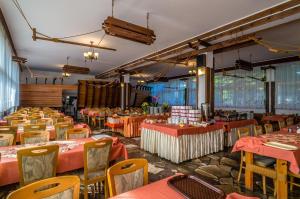 a dining room with tables and chairs and tablesktop at OW Carbo Dąbki - w sąsiedztwie lasu i jeziora in Dąbki +23 photos