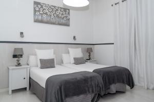 a hotel room with a bed and two lamps at Gran Via 63 Rooms in Madrid