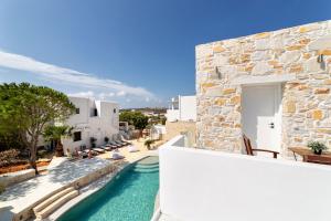 a villa with a swimming pool next to a building at Villa Pela in Aliki