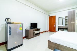 una camera con frigorifero e letto interno di Tree Place a Bangkok