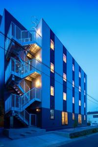 a blue building with a staircase in front of it at HOTEL SOSHA in Ishioka