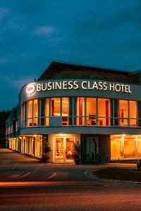 a building with a business glass hotel at night at Business Class Hotel Ebersberg in Ebersberg