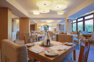 a dining room with a table and chairs at HOTEL*** NAT Bukowina Tatrzańska in Bukowina Tatrzańska