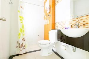a bathroom with a toilet and a sink at Udee Living Place in Hat Yai +41 photos