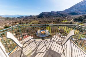 a balcony with chairs and a table with a view at Skadar lake Apartments Pajovic in Virpazar