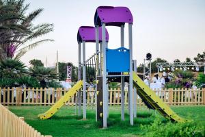 a playground with a slide in a park at Golden Tulip Taj Sultan Resort in Hammamet