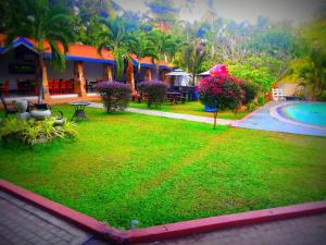 a resort with a yard with a swimming pool at Euro Star Hotel in Katunayaka