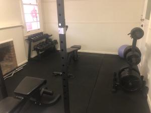 a room with a gym with several machines at The Pink House in Walgett