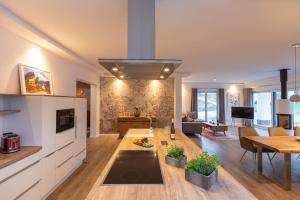 a living room with a kitchen and a dining room at Seeparkvilla in Lychen