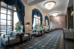 a waiting room with couches and tables and windows at MFK Gornyi Hotel and Congress Centre in Saint Petersburg
