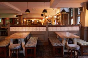 a restaurant with two tables and chairs and a bar at Chase Inn By Greene King Inns in Nuneaton