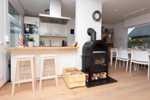 a kitchen with a stove in the middle of a room at Welcome in - Vakantiewoning met ruime tuin en open haard I Horizon 3 Renesse in Renesse