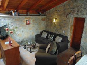 a living room with a couch and a table at Renllon in Lomo de Arico