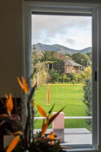 a view of a soccer field through a window at Atlantico Apartments in Ribeira Grande