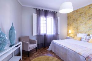 Un pat sau paturi într-o cameră la Atlantico Apartments