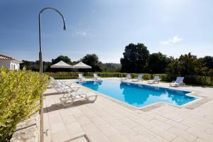 a large swimming pool with lounge chairs at Quinta Do Sobral in Figueiró dos Vinhos