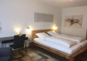 a bedroom with two beds and a desk with lights at Forsthaus Alter Foerster in Bad Oeynhausen