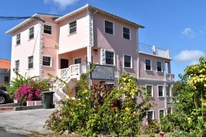 a pink and white building at Aanola Villas A2 Serenity Abode in Charlotte