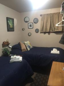 a bedroom with two beds and a table at The Runway House in Cantwell