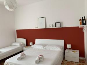 a bedroom with a bed with shoes on it at Talìa in Agira