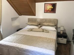 a bedroom with a large bed with white sheets at Center apartment Neno in Split