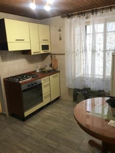 a kitchen with a stove and a table at Center apartment Neno in Split