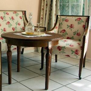 a table and two chairs with a vase on it at Landhaus Ettenbühl Bed and Breakfast in Bad Bellingen