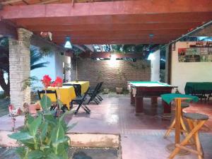a patio with a ping pong table and chairs at Pousada Sao Lourenco in Ubajara
