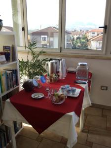 a table in a room with a red table cloth at Il Falco e Il Gabbiano in Corigliano Calabro