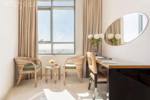 a room with a desk and chairs and a mirror at Staycae Holiday Homes - Capital Bay in Dubai