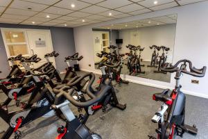 a gym with a bunch of bikes in a room at Holiday Inn Norwich North, an IHG Hotel in Norwich