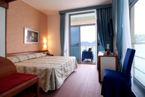 a hotel room with a bed and a large window at Hotel San Terenzo in Lerici