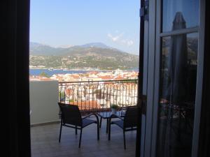 a table and chairs on a balcony with a view at Barbara΄s Apartments in Argostoli