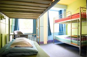 a bedroom with two bunk beds and a window at Portree Independent Hostel in Portree