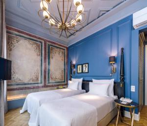 a hotel room with a large bed and a painting on the wall at The Soul Istanbul Hotel in Istanbul