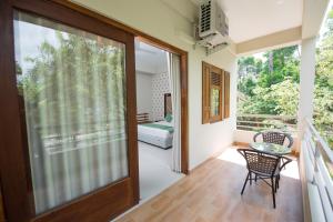 a room with a balcony with a sliding glass door at Mount Rich Rumassala By JMS Group in Unawatuna