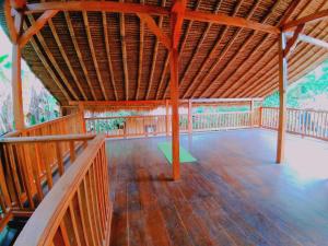 a large room with a wooden floor and a wooden ceiling at Lima Bintang in Gili Trawangan