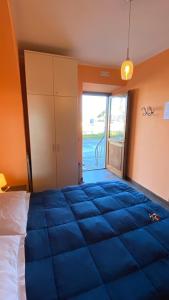 a bedroom with a large blue bed in a room at Alloggio turistico in Capodimonte