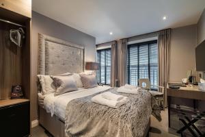 a bedroom with a large bed with towels on it at The Bold Hotel; BW Signature Collection in Southport