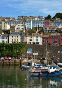 a group of boats docked in a harbor with buildings at Sampford Harbour Side Guest House in Brixham