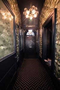 a hallway with a chandelier and a door in a room at Lock and Key Boutique Hotel - Duke Street in Liverpool