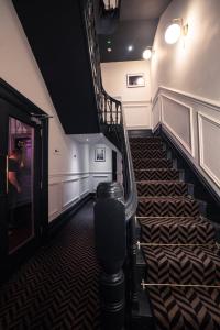 a spiral staircase in a room with a stair case at Lock and Key Boutique Hotel - Duke Street in Liverpool