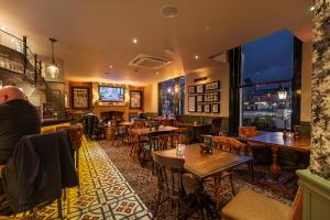 a bar with tables and chairs in a restaurant at The Bold Hotel; BW Signature Collection in Southport