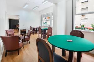 a waiting room with tables and chairs at Savoy Othon in Rio de Janeiro