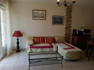 a living room with a couch and a table at Katixa Apartment in Saint-Pée-sur-Nivelle