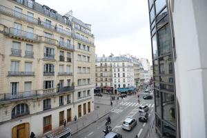 a view of a city street with cars and buildings at LAFAYETTE HOTEL in Paris