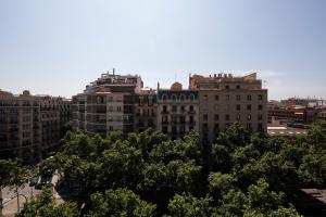 a group of tall buildings in a city at Chic Gran Via Apartment in Barcelona